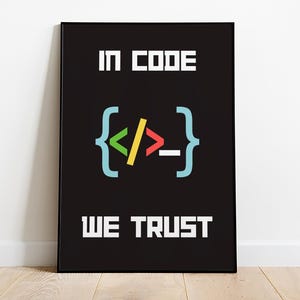 May include: Black and white poster with the text "In Code We Trust" in white letters. The poster features a colorful code bracket symbol with a green left angle bracket, a yellow slash, a red right angle bracket, and a blue underscore.