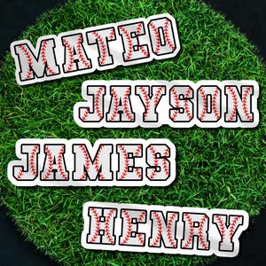 May include: Four baseball-themed name stickers: "MATEO", "JAYSON", "JAMES", and "HENRY". Each name is in a white font with a baseball stitch design, outlined in black, and set against a green grass background.