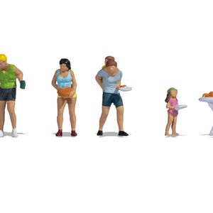 May include: A set of miniature plastic figurines depicting a backyard barbecue scene, including a black grill, a person in a green tank top, a person in a blue top, a person carrying another, a child in a pink outfit, and a person seated at a table.