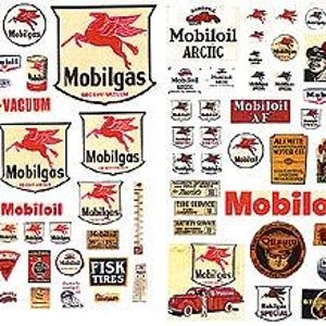May include: A collection of vintage-style Mobilgas and Mobiloil decals featuring the iconic red Pegasus logo, various shield-shaped emblems, rectangular brand signs, and small circular stickers with text, all arranged on a single white sticker sheet.