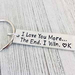 May include: Silver keychain with the text "I Love You More... The End. I Win. ♥ K"
