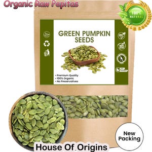 May include: A brown paper bag of green pumpkin seeds with a clear window, and a wooden bowl filled with green pumpkin seeds. The bag has text that reads "Green Pumpkin Seeds", "Organic Raw Pepitas", and "House of Origins".