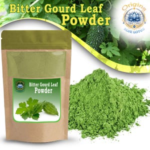 May include: A brown stand-up pouch containing green bitter gourd leaf powder, with a label featuring the text "Bitter Gourd Leaf Powder" and a logo for "Origins Blue Lotus." A pile of the same green powder is displayed next to the pouch.