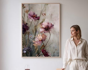 May include: A framed floral painting featuring large, pink and purple flowers with green stems against a muted background. The artwork is displayed in a light-colored wooden frame. The painting is the focal point of a room.