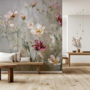 May include: A floral wall mural featuring large, painterly flowers in shades of white, pink, and burgundy against a muted gray background. The artwork is displayed in a room with wooden furniture and flooring, creating a natural and serene atmosphere.