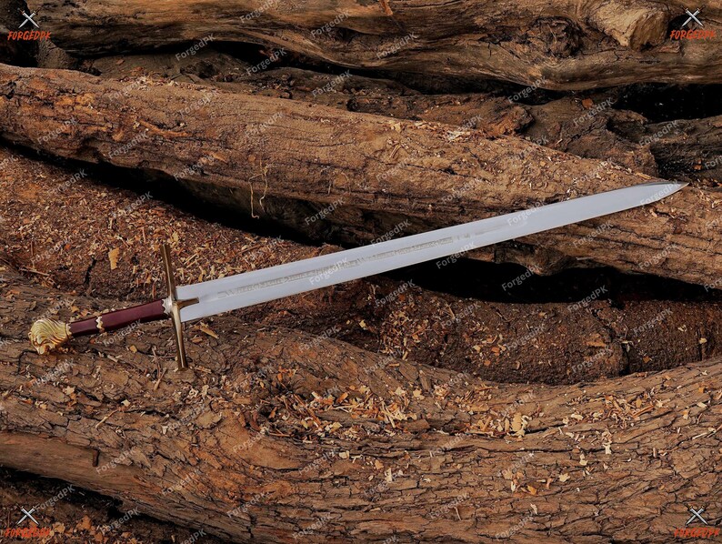 May include: A silver sword with a brown and gold handle resting on a pile of brown tree branches.