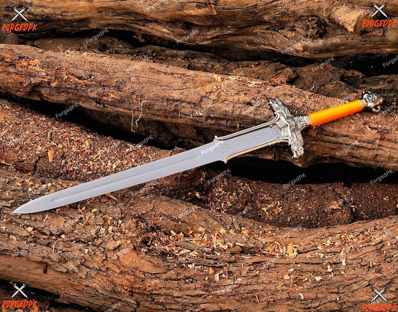 May include: A silver-colored sword with an orange handle and ornate silver crossguard. The blade is long and pointed, and the handle has a detailed design. The sword rests on a bed of rough-hewn wood.