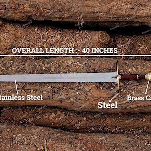 May include: A silver sword with a red and gold handle, resting on a wooden surface. The blade is made of stainless steel, the handle is made of steel, and the pommel is made of brass. The sword is 40 inches long. "OVERALL LENGTH - 40 INCHES" is written above the sword.