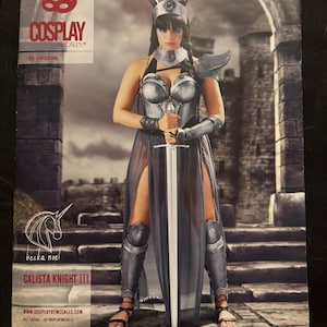 May include: A cosplay pattern for a Calista Knight III costume. The pattern includes a detailed illustration of a woman wearing a silver breastplate, a long grey skirt, and a sword. The pattern is from Cosplay by McCalls.