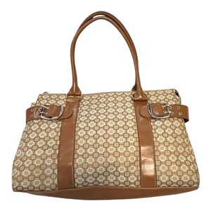 May include: A beige and brown patterned handbag with brown leather accents. The bag features a geometric design, a top zipper, two handles, and two decorative buckles. The bag is designed with a rectangular shape.