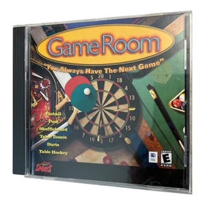 May include: A Game Room CD-ROM in a clear plastic case. The cover features a dartboard, ping pong paddles, and a pool table. Text includes "Game Room" and "You Always Have The Next Game."