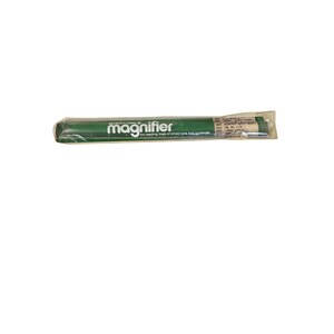 May include: A Bausch & Lomb green bar magnifier encased in clear plastic packaging. The white text on the green surface reads "magnifier" followed by "for reading lines of small type and numerals" with additional small printed text on the right.