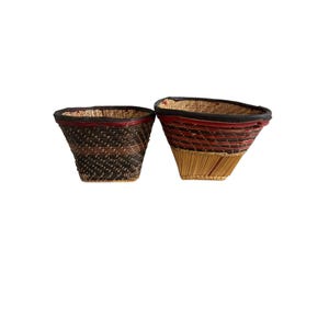 May include: Two woven baskets with flared rims and square bases. The left basket features dark brown and black woven patterns. The right basket displays a combination of natural tan, red, and dark brown woven bands with a dark rim.