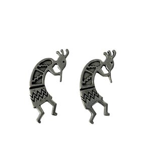 May include: Two silver-colored Kokopelli figures, a Native American symbol of fertility and music, are displayed against a white background. Each figure has a curved body, a flute, and a decorative headdress. The figures are detailed with zig-zag and geometric patterns.
