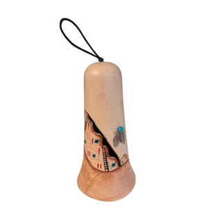 May include: A white ceramic mug with a black handle and the text "But First, Coffee" in a bold, black font. The mug is sitting on a wooden surface. The mug is 4 inches tall.