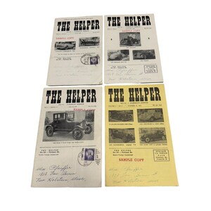 May include: Four vintage issues of The Helper magazine, featuring black and white photographs of antique automobiles on the covers. Two covers are white, one is off-white, and one is yellow. Each includes handwritten addresses and postage stamps.