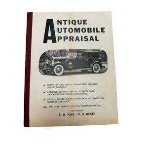 May include: A softcover book titled Antique Automobile Appraisal with a maroon spine and cream cover. The cover features a black and white photograph of a vintage car and text detailing computer analysis, vehicle types, and research services.