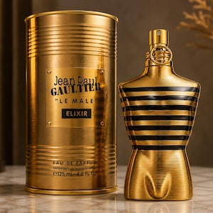 May include: A gold cylindrical canister and a matching gold torso-shaped perfume bottle. The canister features the text Jean Paul GAULTIER LE MALE ELIXIR EAU DE PARFUM 125 ml 4.2 FL OZ. The bottle has horizontal black stripes and a gold spray nozzle.
