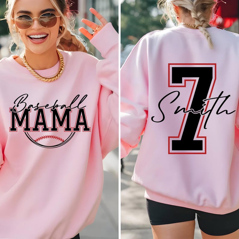 May include: Pink sweatshirt with the text "Baseball Mama" and a baseball graphic on the front. The back of the sweatshirt has a black number 7 with a red outline and the text "Smith" in cursive.