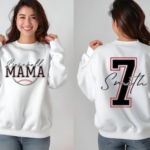 May include: White sweatshirt with the text "Baseball Mama" and a baseball graphic on the front. The back of the sweatshirt has a large black number "7" with the text "Smith" in a script font.