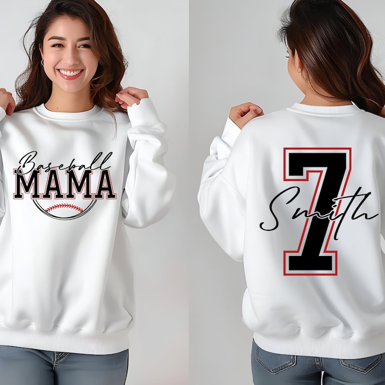 May include: White sweatshirt with the text "Baseball Mama" and a baseball graphic on the front. The back of the sweatshirt has a large black number "7" with the text "Smith" in a script font.