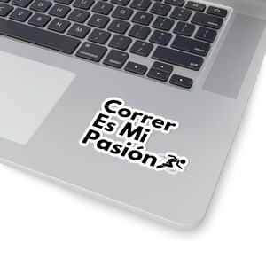 May include: A white sticker with black text that reads "Correr Es Mi Pasión" with a running person icon. The sticker is on a silver laptop.