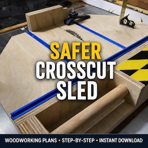 May include: A plywood crosscut sled for a table saw featuring blue T-track rails, a cylindrical wooden handle, and a black and yellow hazard stripe pattern. The text reads SAFER CROSSCUT SLED, WOODWORKING PLANS, STEP-BY-STEP, and INSTANT DOWNLOAD.