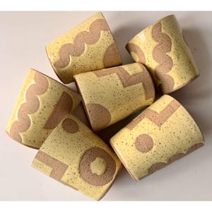 May include: A handmade wooden sign with the text "Welcome" in a playful font. The sign features a distressed white background and a dark brown frame, perfect for a front door or entryway. The sign measures approximately 12 inches wide and 6 inches tall.