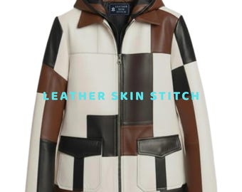 Könnte beinhalten: Eine Kapuzenjacke mit einem Patchwork-Design aus weißen, schwarzen und braunen Lederbahnen. Die Jacke verfügt über einen Frontreißverschluss, einen Kragen und zwei große Vordertaschen mit Klappen. Ein Etikett im Nacken zeigt LEATHER SKIN STITCH.