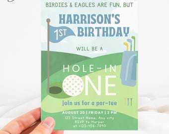 May include: A golf-themed birthday invitation with the text "Harrison's 1st Birthday." The design features a golf ball, flag, golf bag, and the words "Hole-in-One." The invitation includes event details and RSVP information.