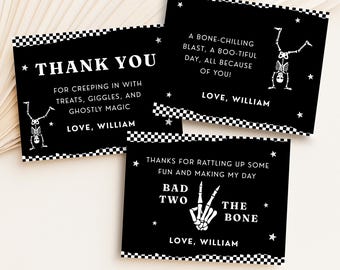 May include: Black and white Halloween-themed cards with various messages. One card reads "THANK YOU" with a skeleton illustration. Another says "A bone-chilling blast..." and the third says "Thanks for rattling up some fun..." All cards have a checkered border.