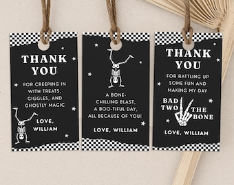 May include: Three black Halloween-themed gift tags with white text and illustrations. Each tag has a checkered border and a jute string. The tags say "Thank You" and include skeleton graphics and festive phrases.