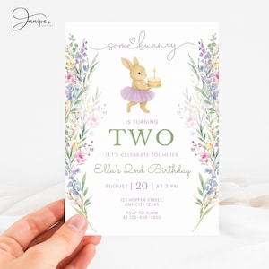 May include: A whimsical birthday invitation featuring a watercolor illustration of a bunny wearing a tutu and holding a cake. The text reads "Some Bunny is Turning Two" with event details. Floral accents frame the design, with the Juniper Papers logo in the top left corner.