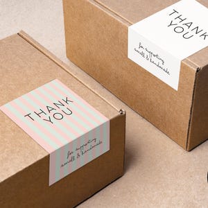 May include: Two brown cardboard boxes with white and pink striped thank you stickers. The stickers say "Thank You" and "for supporting small & handmade".