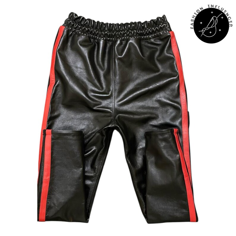 May include: Black leather pants with red side stripes and an elastic waistband. The pants have a shiny finish and a casual, sporty style. The Fashion Influencer logo is in the upper right corner.