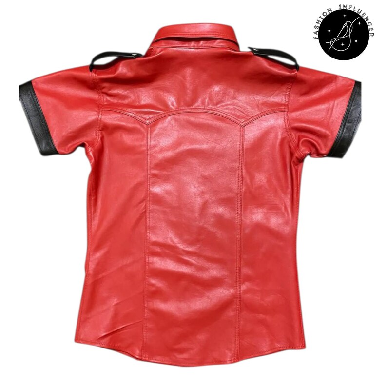 May include: A red leather short-sleeve shirt with black accents on the collar and sleeves. The shirt has a classic collar and shoulder epaulettes. The Fashion Influencer logo is in the upper right corner.