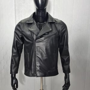 May include: A black leather jacket with a zipper closure and a stand-up collar.