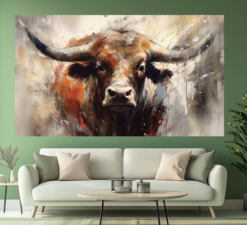 May include: A large canvas print of a bull's head, rendered in an abstract style. The artwork features a close-up of the bull's face with prominent horns, showcasing a palette of browns, oranges, and whites. The painting is displayed above a white sofa.