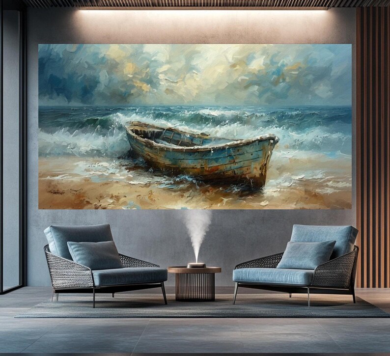 May include: Large wall art featuring an oil painting of a weathered blue boat on a sandy beach, with foamy waves and a cloudy sky. The artwork is displayed above two blue armchairs in a modern living room setting.