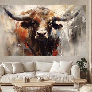 May include: An abstract painting of a bull's head, featuring a brown and orange color palette with black accents. The artwork has a textured, brushstroke style, with the bull's horns prominently displayed. The background is a mix of neutral tones.