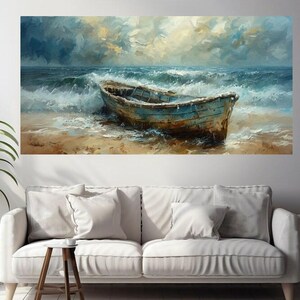 May include: An oil painting depicts a weathered blue boat on a sandy beach, with foamy waves crashing around it. The sky is a mix of blues and yellows, suggesting a stormy or overcast day. The artwork is displayed above a white sofa.