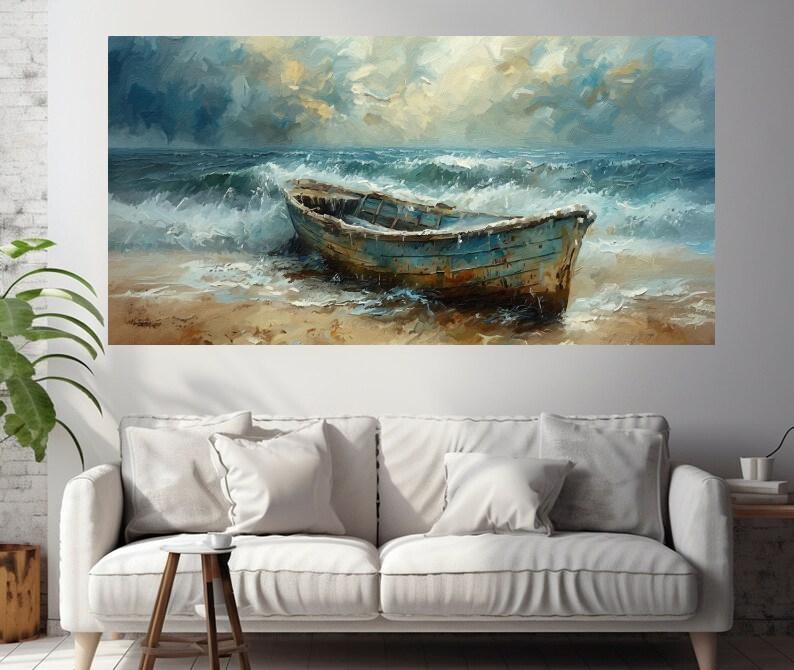 May include: An oil painting depicts a weathered blue boat on a sandy beach, with foamy waves crashing around it. The sky is a mix of blues and yellows, suggesting a stormy or overcast day. The artwork is displayed above a white sofa.