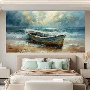 May include: A large canvas print of a seascape featuring a weathered blue boat on a sandy shore. The artwork depicts a turbulent sea with crashing waves under a cloudy sky, evoking a sense of drama and movement. The painting's color palette includes blues, browns, and whites.