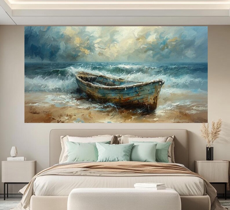 May include: A large canvas print of a seascape featuring a weathered blue boat on a sandy shore. The artwork depicts a turbulent sea with crashing waves under a cloudy sky, evoking a sense of drama and movement. The painting's color palette includes blues, browns, and whites.