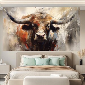 May include: Large wall art featuring a close-up of a bull's head. The artwork uses a palette of browns, oranges, and grays, with visible brushstrokes creating a textured effect. The bull's horns are prominent, and the overall style is abstract and expressive.