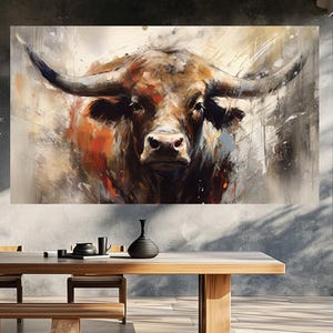 May include: A large canvas print of a bull's head, rendered in an abstract style with brown, orange, and gray tones. The artwork features a detailed depiction of the bull's face and horns, with brushstrokes creating a textured effect. The print is displayed above a wooden dining table.