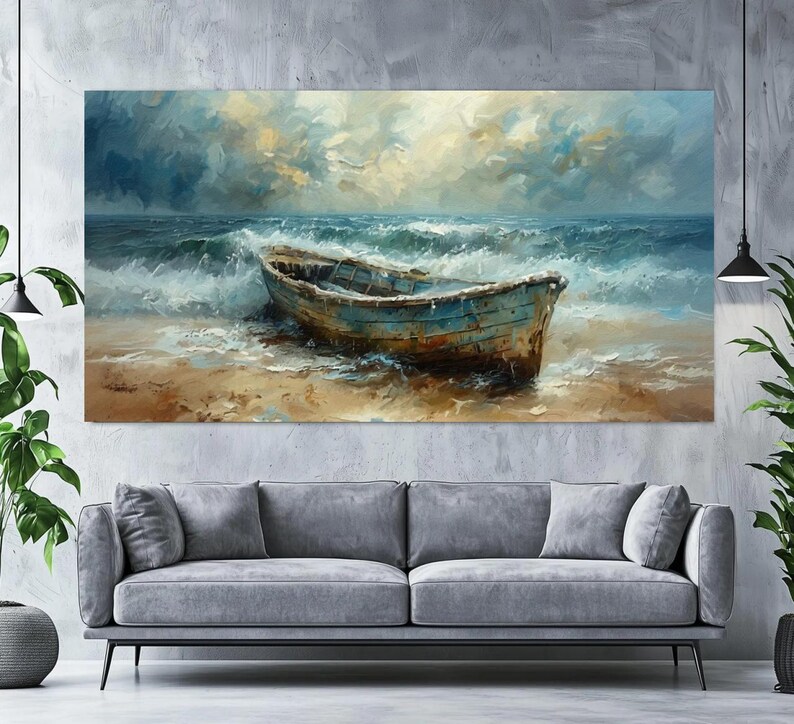 May include: An oil painting depicts a weathered blue boat on a sandy beach, with foamy waves crashing around it. The sky is filled with dramatic clouds, and the overall color palette is dominated by blues, browns, and whites. The artwork is displayed above a gray sofa.