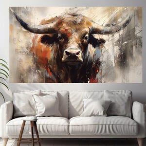 May include: A large canvas print of a bull's head, rendered in an abstract style with a focus on texture and color. The artwork features a palette of browns, oranges, and grays, with visible brushstrokes. The bull's horns are prominent, and the overall effect is bold and expressive.