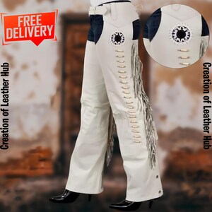 May include: White leather riding pants with fringe detail and a decorative design on the side. The pants have a belt loop and a zipper closure.