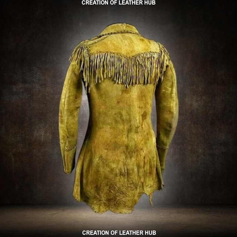 May include: A yellow leather jacket with fringe detailing. The jacket is made of suede and has a long, flowing style.  "CREATION OF LEATHER HUB" is printed at the top and bottom of the image.